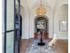 Elegant foyer with a woven chandelier, a round wooden table, a patterned rug, and herringbone floors at 1297 Swims Valley Nw Dr, Atlanta, GA 30327