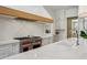 Modern kitchen features stainless steel range, quartz countertops, and custom white cabinetry at 1297 Swims Valley Nw Dr, Atlanta, GA 30327