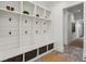 Functional mudroom with white shiplap, built-in shelving, hooks, and wicker baskets for organized storage solutions at 1297 Swims Valley Nw Dr, Atlanta, GA 30327
