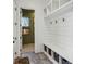 Stylish mudroom with built-in shelving, hooks, bench, and storage baskets, leading to an outdoor entrance at 1297 Swims Valley Nw Dr, Atlanta, GA 30327