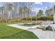 A backyard featuring a modern pool with a sun deck and lounge chairs provides a relaxing outdoor space at 1297 Swims Valley Nw Dr, Atlanta, GA 30327