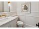 Chic powder room featuring marble countertops, modern fixtures, and stylish wall decor at 1297 Swims Valley Nw Dr, Atlanta, GA 30327