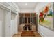 Modern sauna room featuring natural wood and glass enclosure near a built-in closet system with warm, natural lighting at 1297 Swims Valley Nw Dr, Atlanta, GA 30327