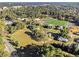 Wide aerial shot capturing the neighborhood's school and athletic field amidst the surrounding forest at 427 S Columbia Dr, Decatur, GA 30030