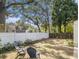 Spacious backyard featuring a white fence, mature trees, and seating area, perfect for outdoor enjoyment at 427 S Columbia Dr, Decatur, GA 30030
