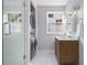 Elegant bathroom with a glass-enclosed shower, stacked washer/dryer, and stylish vanity at 427 S Columbia Dr, Decatur, GA 30030
