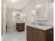 Bathroom featuring double vanity with marble countertop, tile flooring, and glass-enclosed shower at 427 S Columbia Dr, Decatur, GA 30030