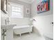 Charming bathroom with a claw-foot tub, pedestal sink, and beadboard paneling, exuding classic elegance at 427 S Columbia Dr, Decatur, GA 30030