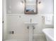 Bathroom featuring pedestal sink, wood-framed mirror, modern lighting, and beadboard paneling at 427 S Columbia Dr, Decatur, GA 30030