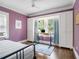 Bedroom with purple walls, hardwood floors, a built-in closet and ample sunlight from the window at 427 S Columbia Dr, Decatur, GA 30030