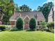 Charming cottage-style home featuring dormer windows, stone accents, and a well-manicured lawn at 427 S Columbia Dr, Decatur, GA 30030