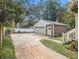 View of detached two-car garage with driveway, garden, and steps leading to a side door at 427 S Columbia Dr, Decatur, GA 30030