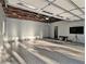 Large, well-lit garage with epoxy floors and modern fixtures, providing ample space for storage at 427 S Columbia Dr, Decatur, GA 30030