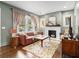 Cozy living room with a decorative fireplace, plush sofa, and hardwood floors at 427 S Columbia Dr, Decatur, GA 30030