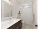Clean bathroom with dark wood vanity, framed mirror, and shower curtain at 6460 Cortland Walk, Alpharetta, GA 30005