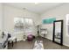 Bright bedroom with hardwood floors, large window, neutral colors and professional photography equipment set up at 6460 Cortland Walk, Alpharetta, GA 30005