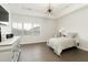 Bright bedroom with modern lighting, tray ceiling, and plenty of natural light at 6460 Cortland Walk, Alpharetta, GA 30005