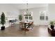 Bright dining area with modern chandelier lighting and large windows with natural light at 6460 Cortland Walk, Alpharetta, GA 30005