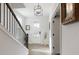 Bright foyer featuring hardwood floors, staircase with black metal railings, and natural light at 6460 Cortland Walk, Alpharetta, GA 30005