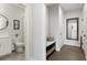 Hallway with tiled bathroom and a bench with storage drawers at 6460 Cortland Walk, Alpharetta, GA 30005