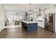 Modern open-concept kitchen with large island, stainless steel appliances, and abundant natural light at 6460 Cortland Walk, Alpharetta, GA 30005