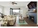 Bright living room with a cozy fireplace, ceiling fan, and access to an outdoor balcony at 6460 Cortland Walk, Alpharetta, GA 30005