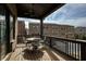 Charming covered patio includes ceiling fan, wrought-iron railing and outdoor furniture at 6460 Cortland Walk, Alpharetta, GA 30005