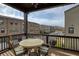 Relaxing covered patio with stylish outdoor furniture and railing overlooking charming street view at 6460 Cortland Walk, Alpharetta, GA 30005