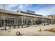 Modern storefront with large glass windows and outdoor seating in a landscaped area at 6460 Cortland Walk, Alpharetta, GA 30005
