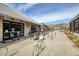 Modern storefront with brick accents, outdoor seating, and bike racks near a sidewalk at 6460 Cortland Walk, Alpharetta, GA 30005