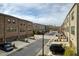 Attractive street view showcasing townhouse-style condos with garages and landscaping at 6460 Cortland Walk, Alpharetta, GA 30005