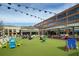 Outdoor community area with shops, restaurants, a lawn area, and recreational seating at 6460 Cortland Walk, Alpharetta, GA 30005