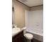 A bathroom with a tub, tile surround, vanity with a sink, and modern fixtures at 155 Emily Dr, Whitesburg, GA 30185