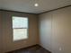 Bedroom features a window overlooking the backyard at 155 Emily Dr, Whitesburg, GA 30185