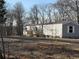 Exterior of home with new wooden deck, surrounded by a natural landscape at 155 Emily Dr, Whitesburg, GA 30185