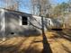 Exterior view of home with gray siding, white trim, and wood deck at 155 Emily Dr, Whitesburg, GA 30185