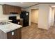This kitchen features wood-look flooring, wooden cabinets, and updated appliances at 155 Emily Dr, Whitesburg, GA 30185
