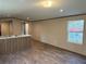 Bright living room features wood-look flooring and a view from the window at 155 Emily Dr, Whitesburg, GA 30185