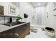 Modern bathroom featuring marble countertops, black accents, and a glass-enclosed shower with designer tile at 1812 Hunters Gln, Marietta, GA 30062