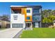 Modern home showcasing a three-story facade with mixed textures, large windows, and an attached garage at 1812 Hunters Gln, Marietta, GA 30062