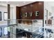 Bright foyer with a glass floor showcasing a unique design and modern wood paneled walls with decorative letters at 1812 Hunters Gln, Marietta, GA 30062