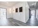 Hallway featuring gray wood floors, marble accent wall, and decorative lighting at 1812 Hunters Gln, Marietta, GA 30062