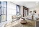 Bright living room with modern sofas, plush rug, and large windows with sheer curtains at 1812 Hunters Gln, Marietta, GA 30062