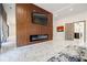 Open-concept living area showcasing a modern electric fireplace, sleek wood-slat accent wall, and marble flooring at 1812 Hunters Gln, Marietta, GA 30062
