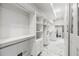 Spacious walk-in closet featuring custom shelving, drawers, and ample storage space, plus marble floors and washer/dryer hookups at 1812 Hunters Gln, Marietta, GA 30062