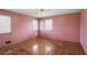 Bedroom with hardwood flooring, two windows, ceiling fan and pink painted walls at 2165 Sterling Ridge Rd, Decatur, GA 30032