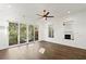 Bright living room featuring hardwood floors, modern ceiling fan, and sliding glass doors to the outdoors at 2335 Mason Dr # D27, Atlanta, GA 30316