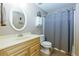 Bathroom with a single sink vanity, toilet, and shower with a curtain at 328 Wickley Way, Woodstock, GA 30188