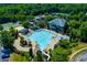 Aerial view of a community pool with waterslide, chairs and umbrellas in a landscaped setting at 328 Wickley Way, Woodstock, GA 30188