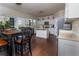 Open concept kitchen with white cabinets, stainless steel appliances, and hardwood floors at 328 Wickley Way, Woodstock, GA 30188